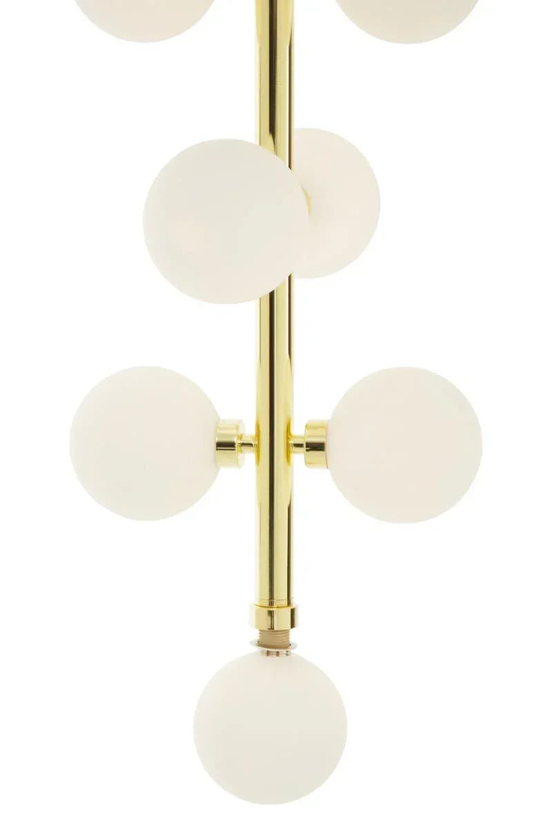 Gold chandelier with frosted glass globes in modern vertical arrangement