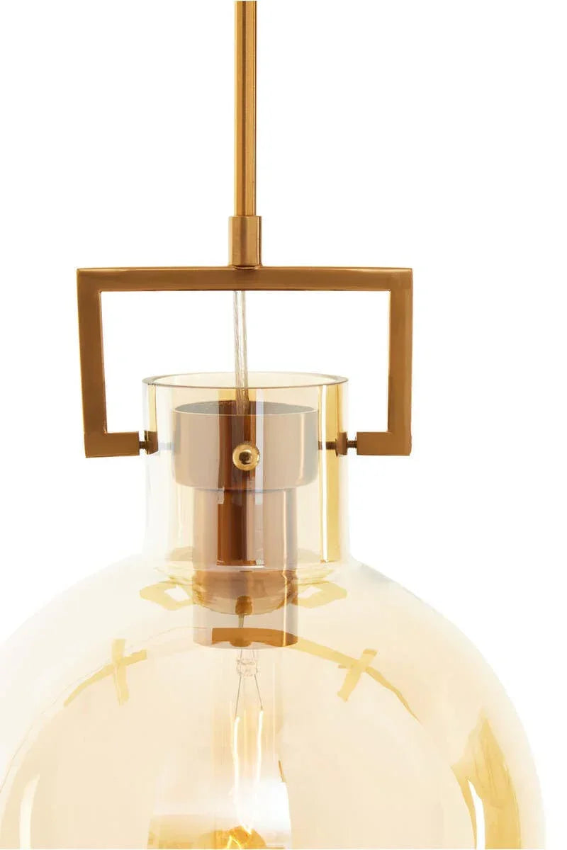 Amber glass pendant light with gold metal frame and exposed bulb, close-up view