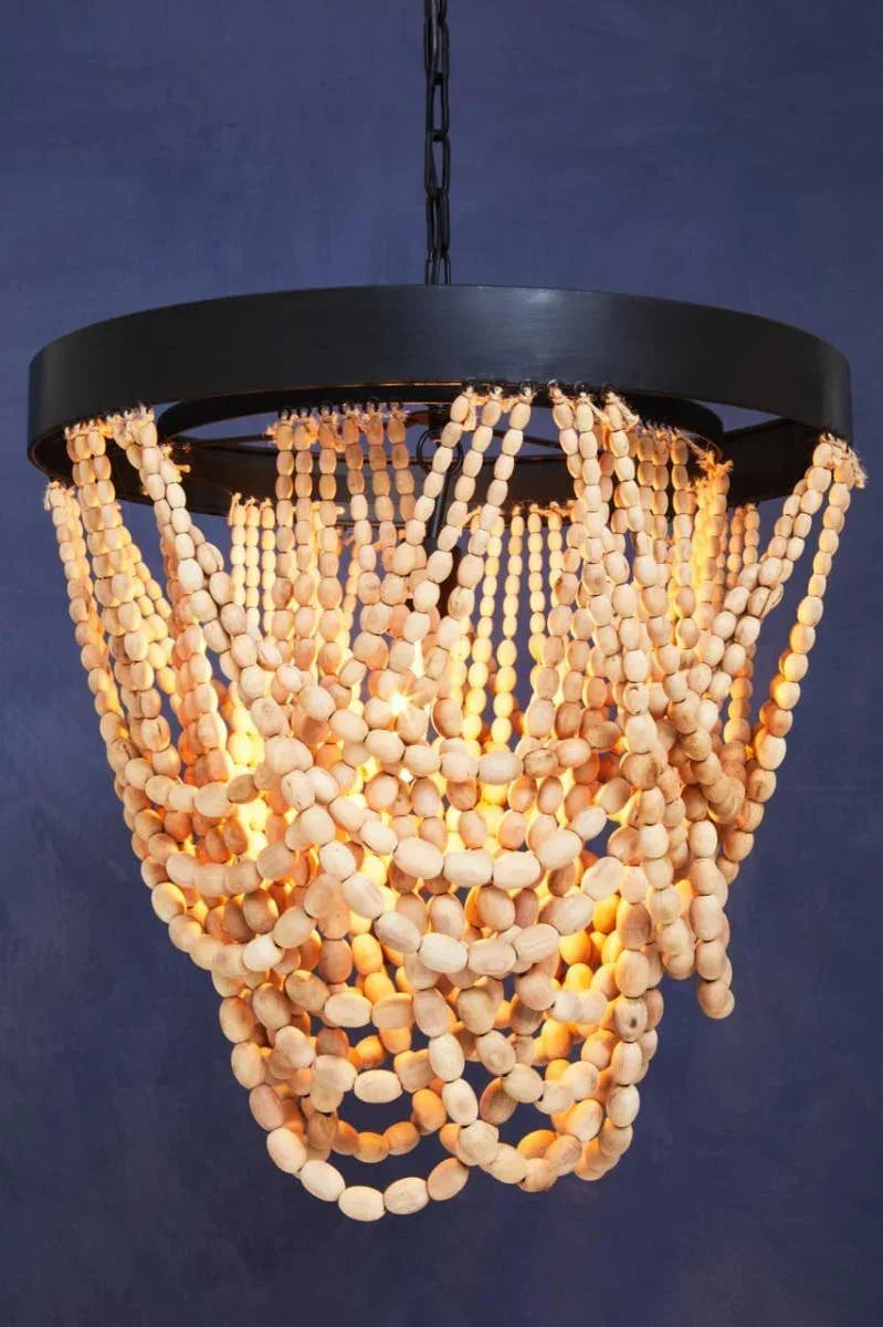 Wood bead chandelier with black frame and warm lighting against dark blue wall