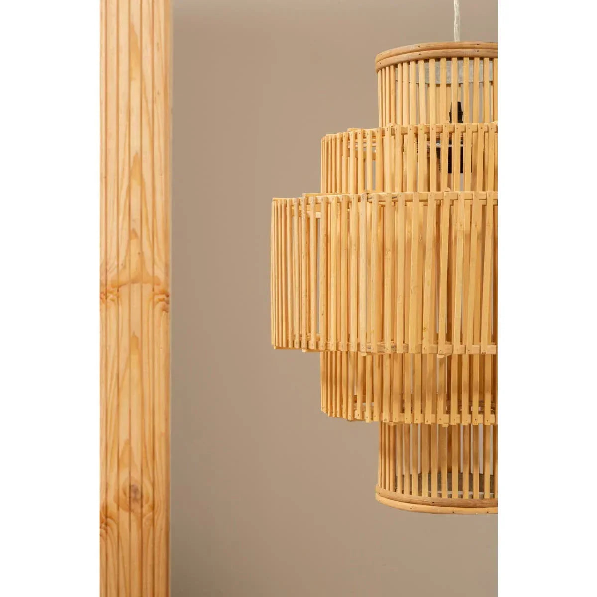 Natural rattan pendant light with layered bamboo slats against beige wall
