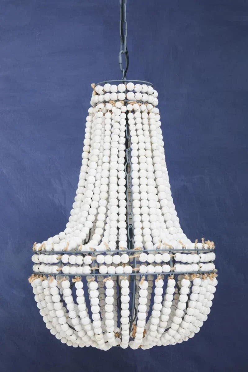 White beaded chandelier light fixture against a blue background, boho style home decor