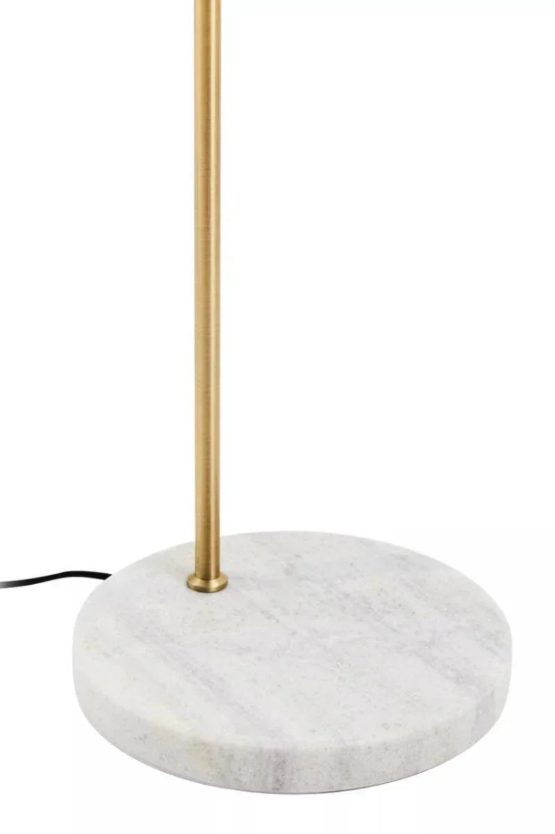 Brass floor lamp with round white marble base, close-up of base and upright stand