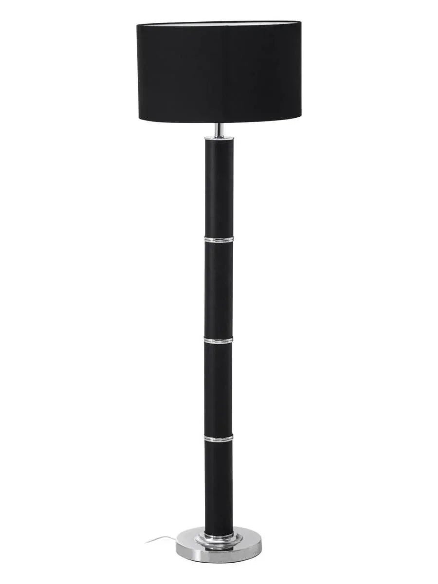 Black floor lamp with chrome accents and round base on white background