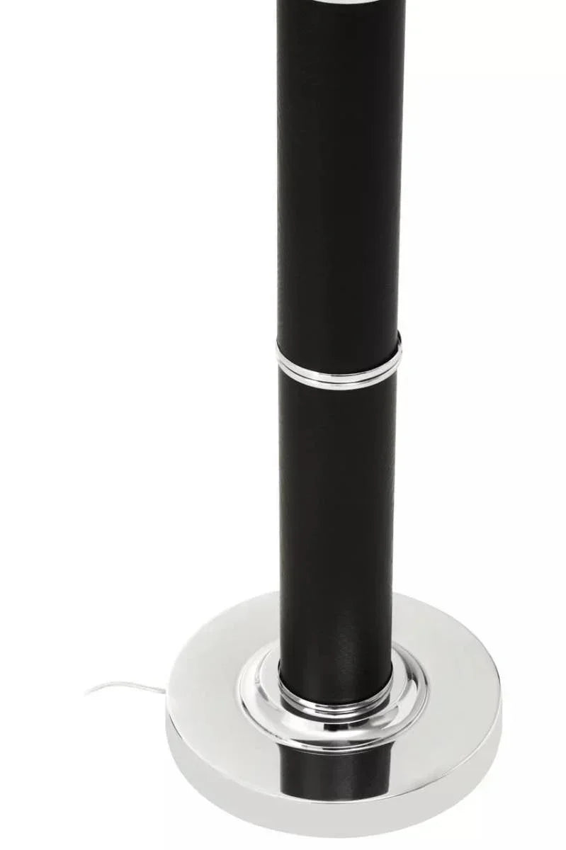 Black floor lamp base with chrome trim and visible power cable