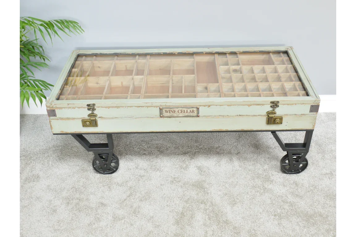 Industrial style glass top coffee table with metal wheels and wooden compartment storage