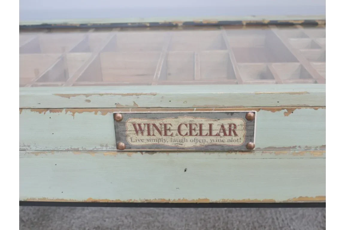 Rustic wooden wine storage table with labelled metal plaque and glass top compartments