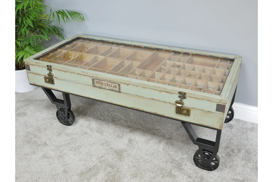 Industrial style coffee table with glass top, wine storage compartments and metal wheels