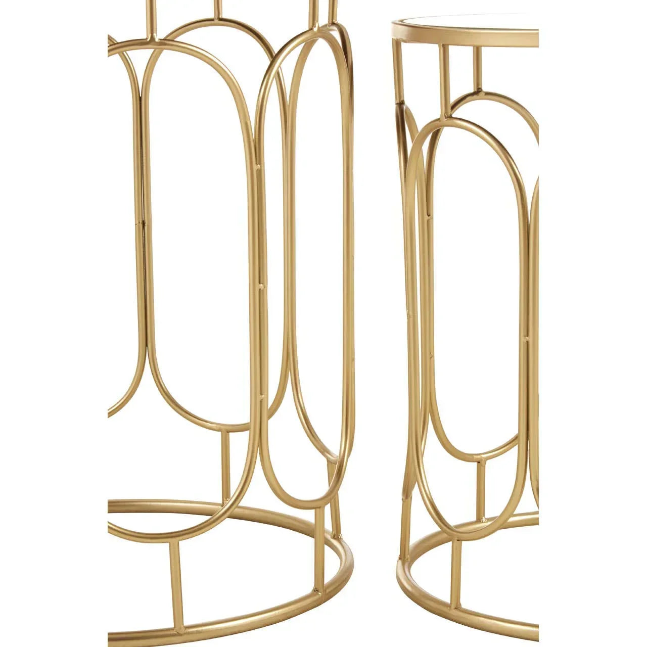 Gold metal side tables with geometric openwork bases shown from a close angle