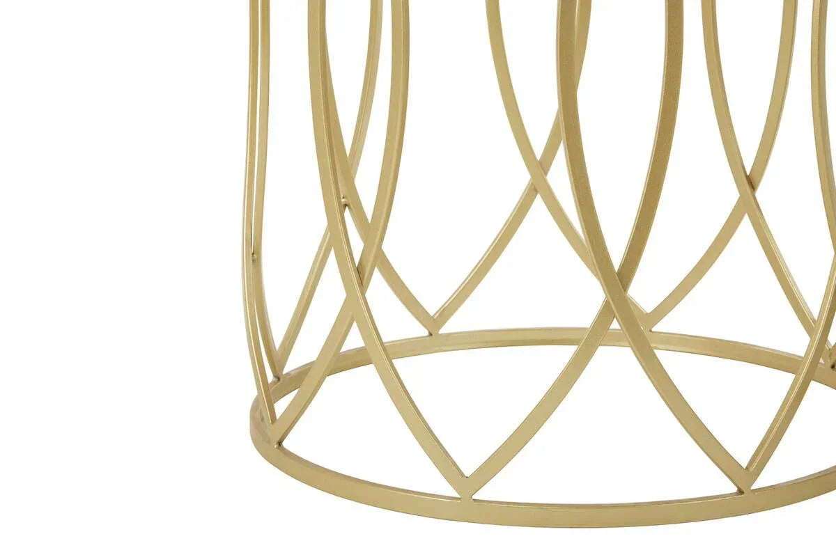Gold metal coffee table base with geometric openwork design, close-up side view