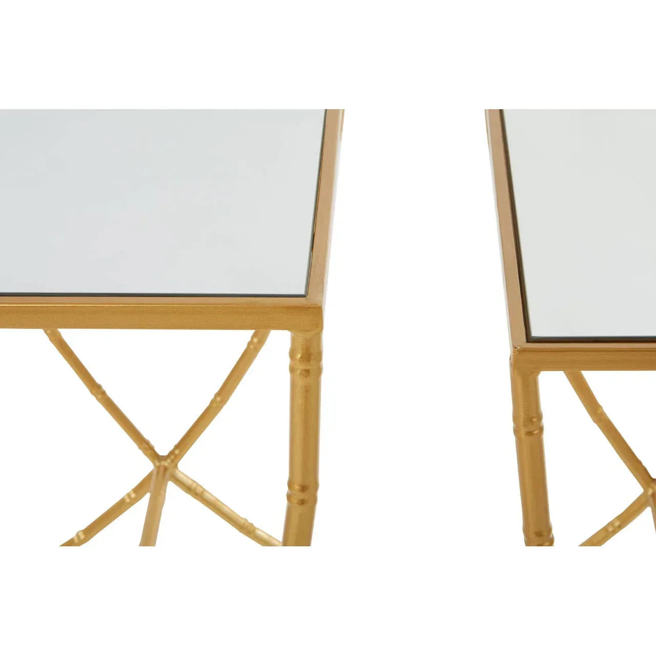 Closeup of gold metal frame side tables with mirrored tops and crossed leg detail