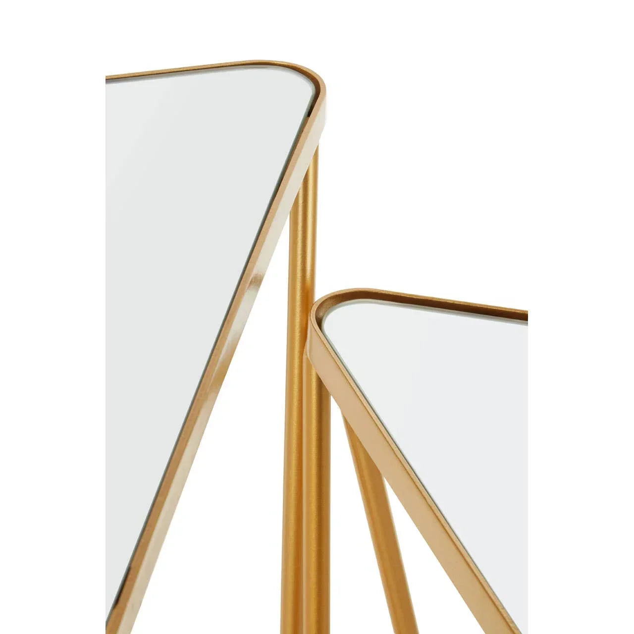 Gold metal frame nesting tables with white glass tops, close-up corner view
