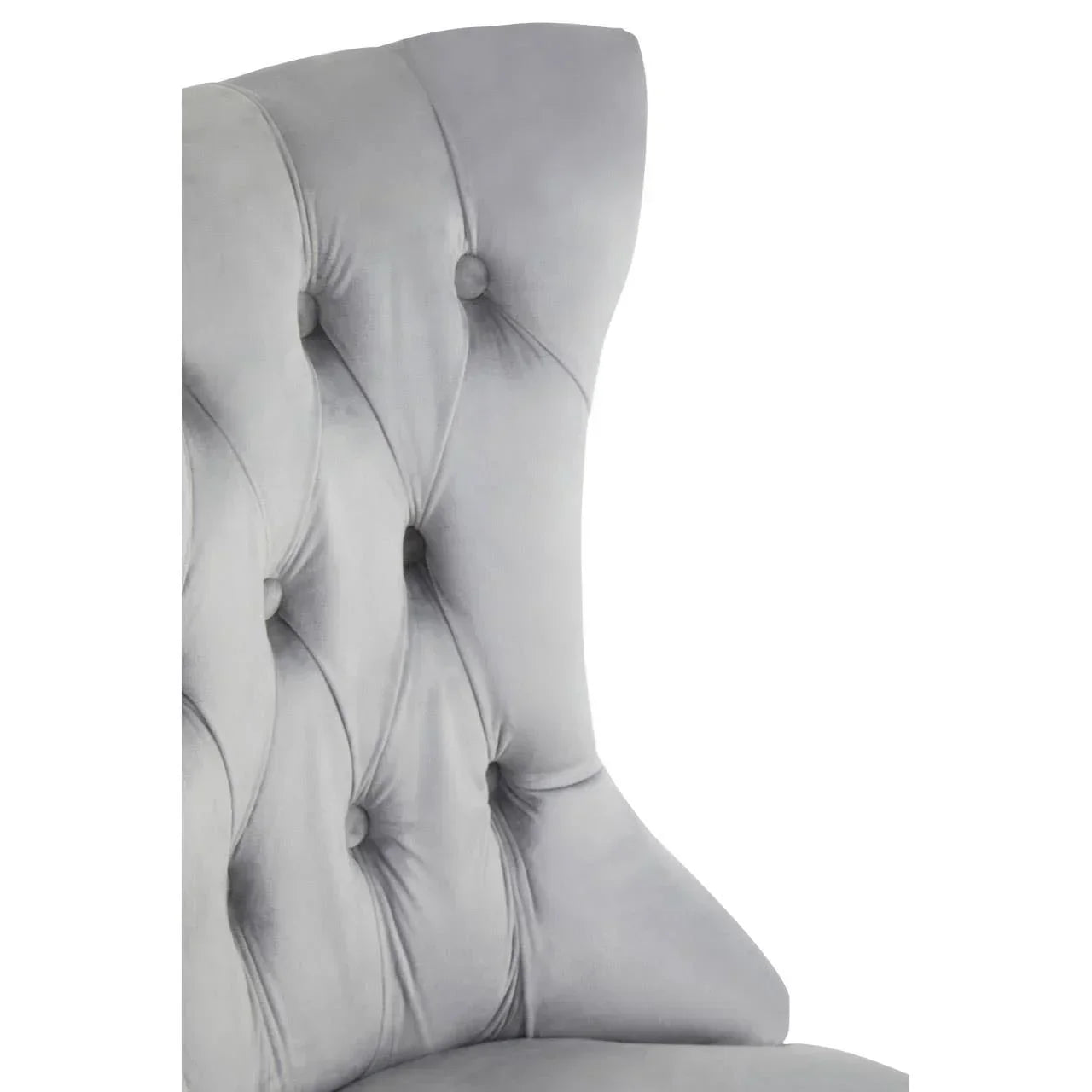 Light grey velvet chair featuring button-tufted backrest and curved wingback design