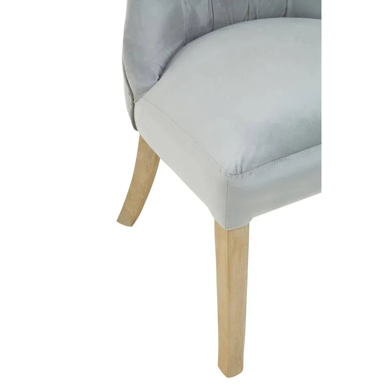 Light grey fabric dining chair with natural wooden legs, close-up of seat and legs