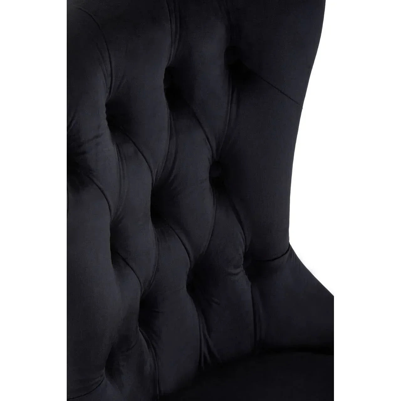 Black velvet chair with deep button-tufted backrest upholstery detail