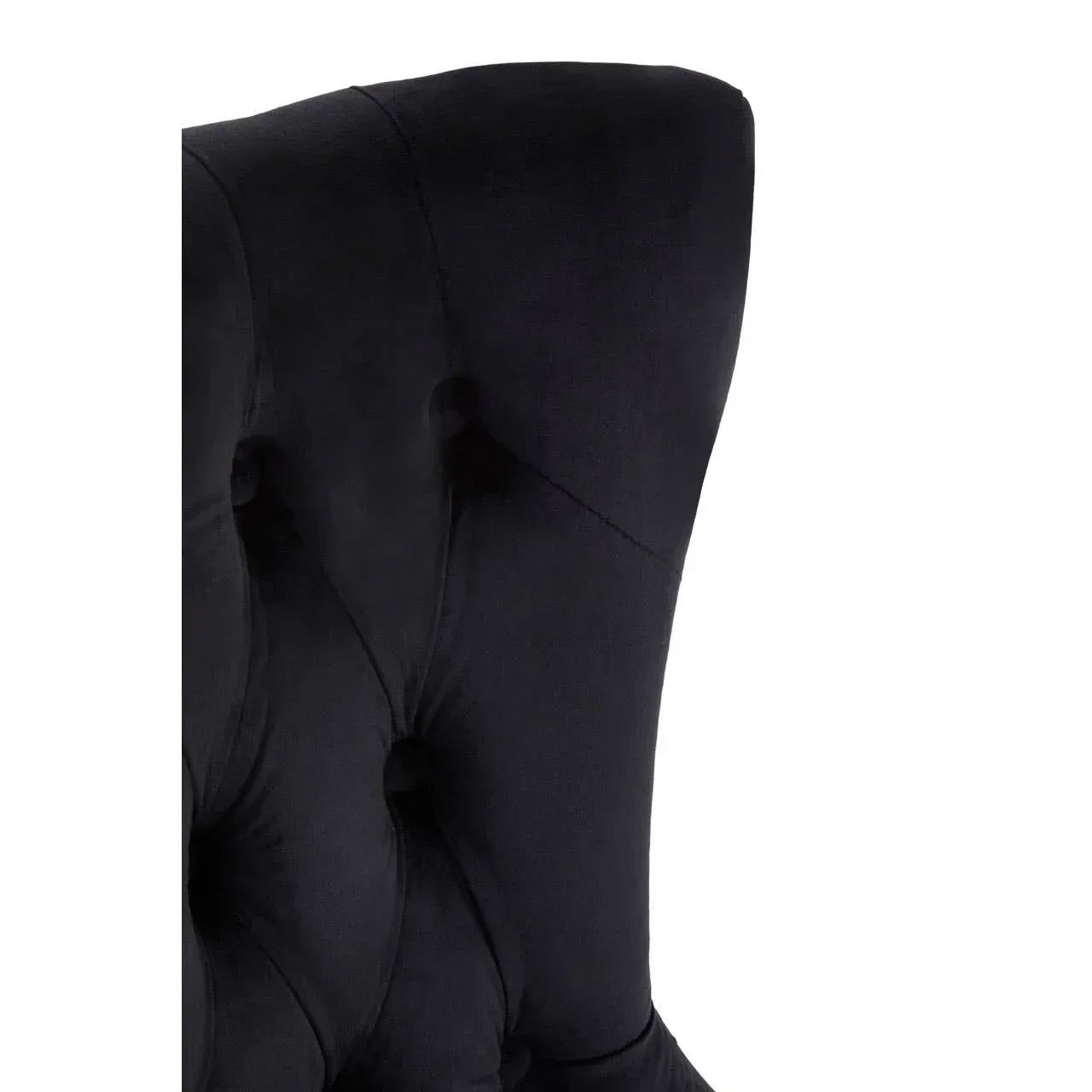 Black velvet dining chair with high wingback and button-tufted upholstery, closeup view