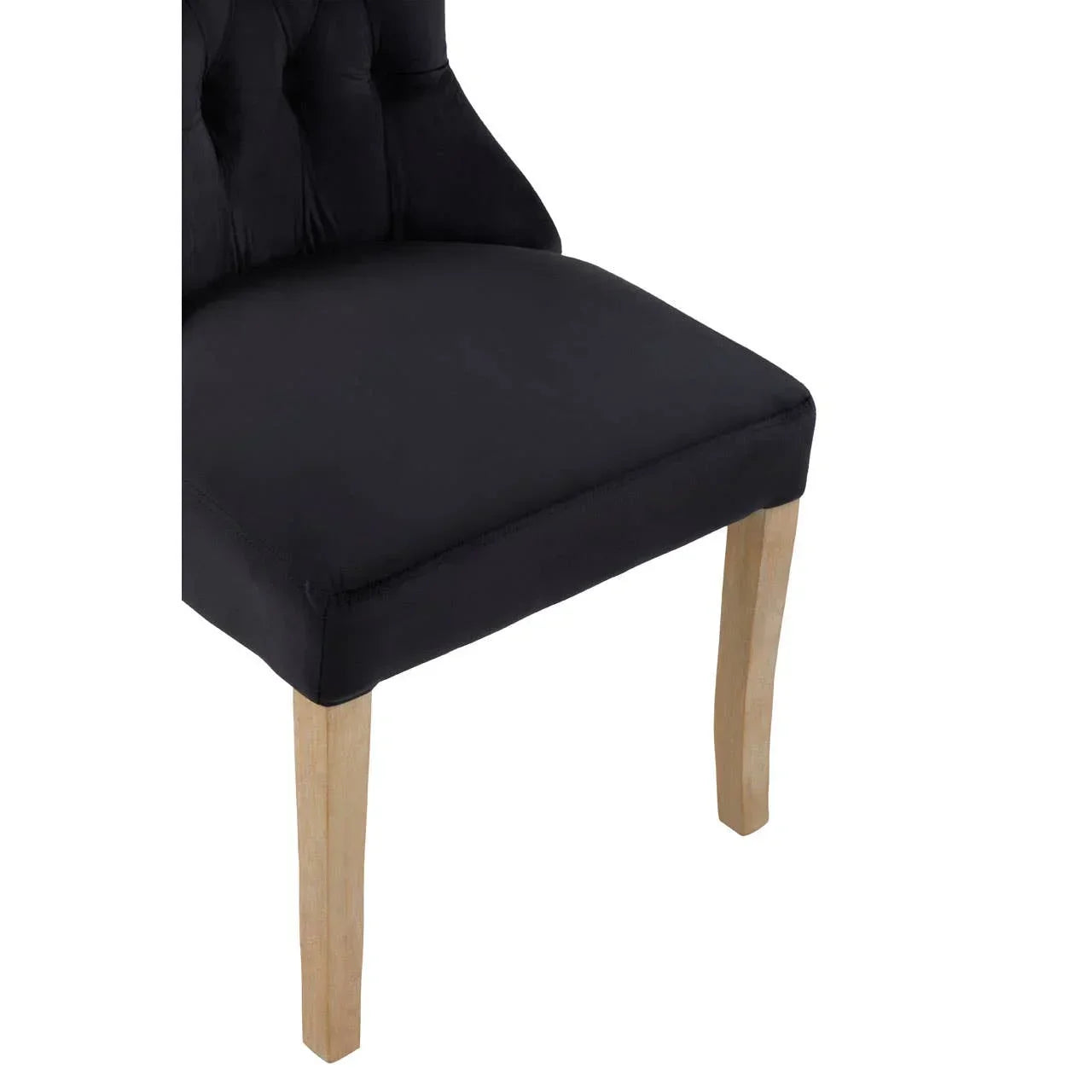 Black upholstered dining chair with wooden legs, partial side angle