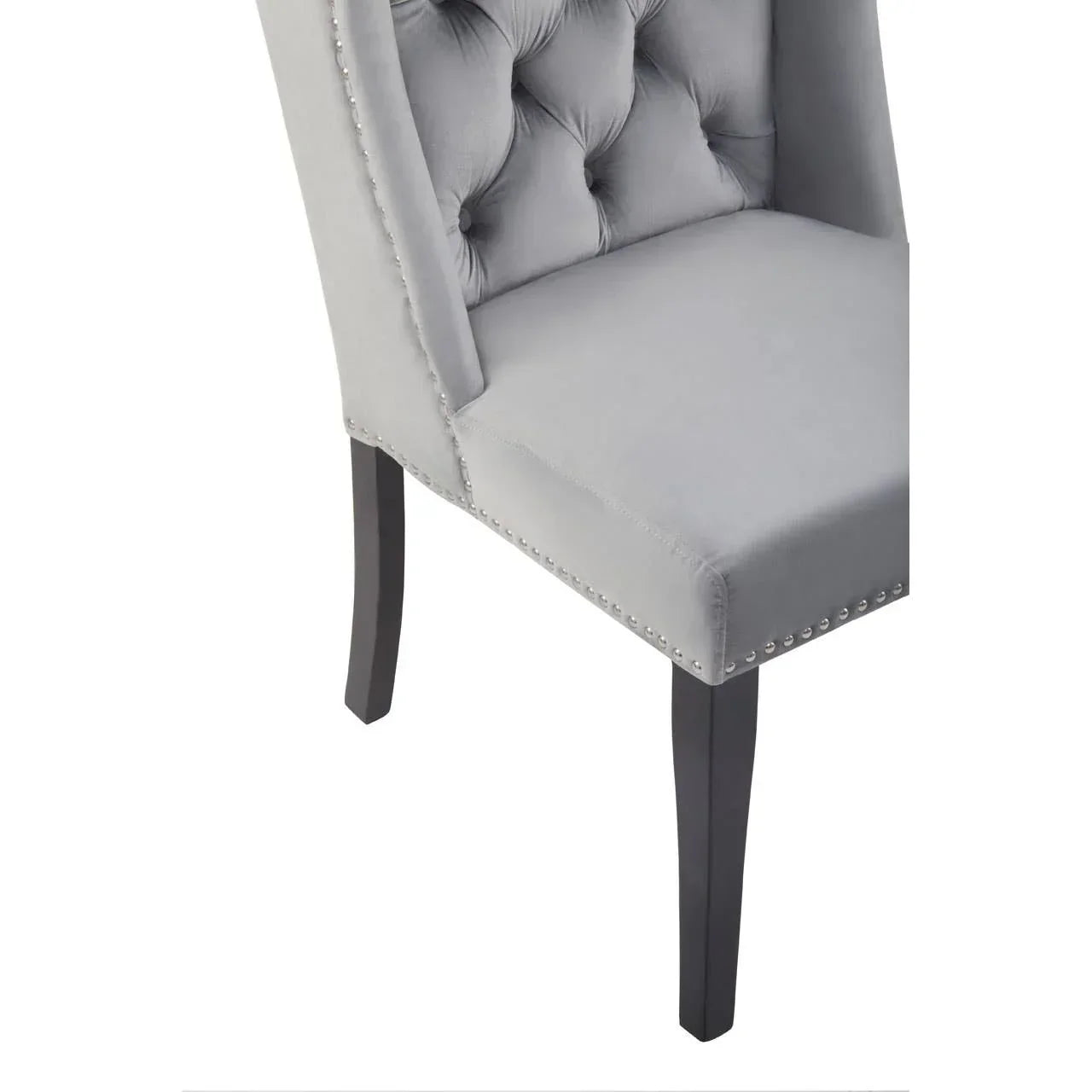 grey velvet dining chair with button tufting and silver stud trim, angled front view