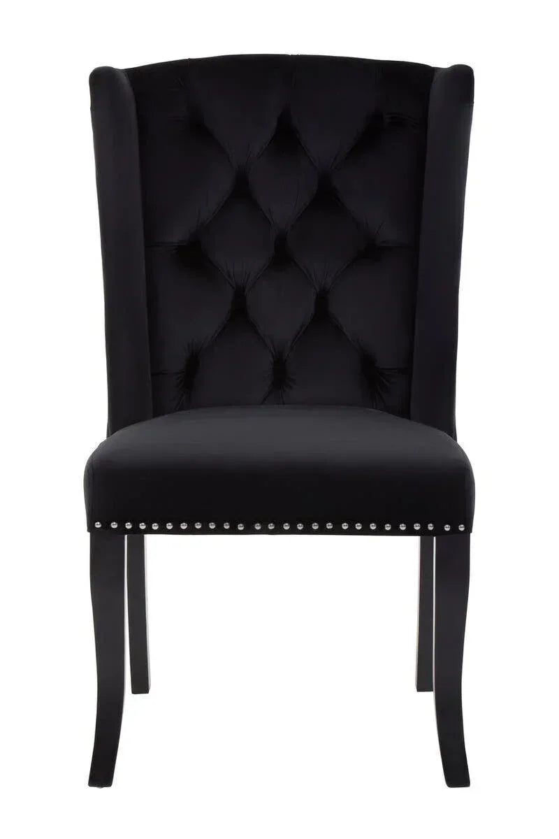 Black velvet dining chair with tufted backrest and stud detail, front view