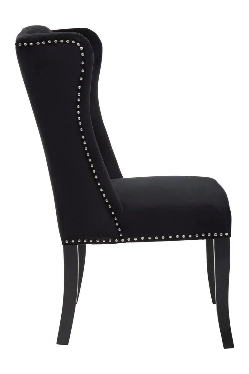 Black upholstered dining chair with silver stud trim, side view