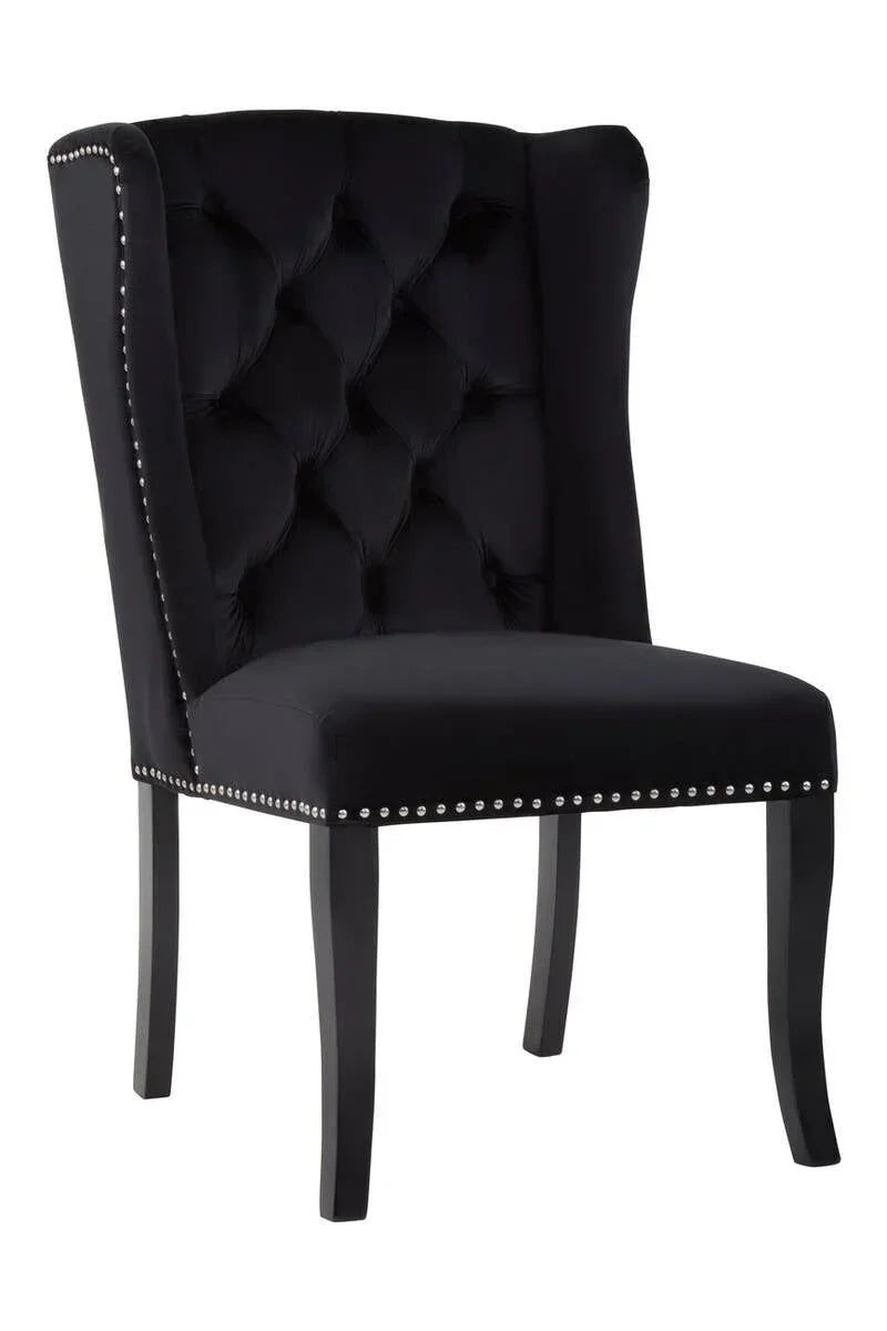 Black velvet dining chair with button-tufted backrest and silver studded trim