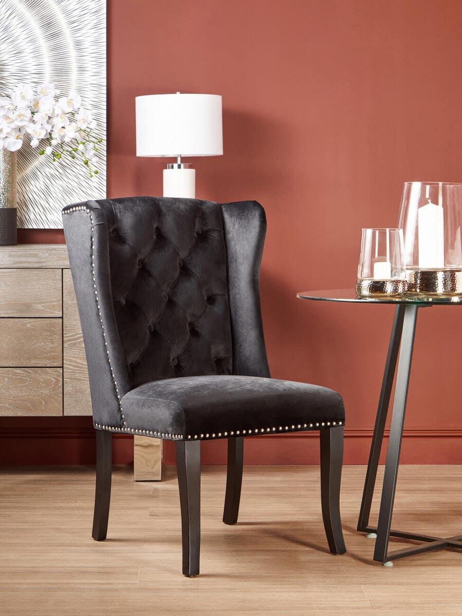 Black velvet dining chair with stud detailing in modern room setting