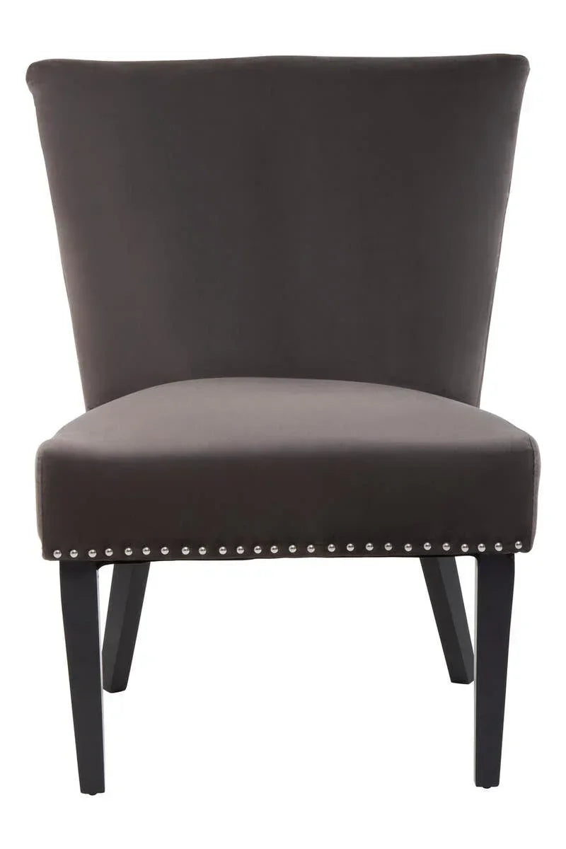 Dark grey accent chair with velvet upholstery and silver stud details on black legs