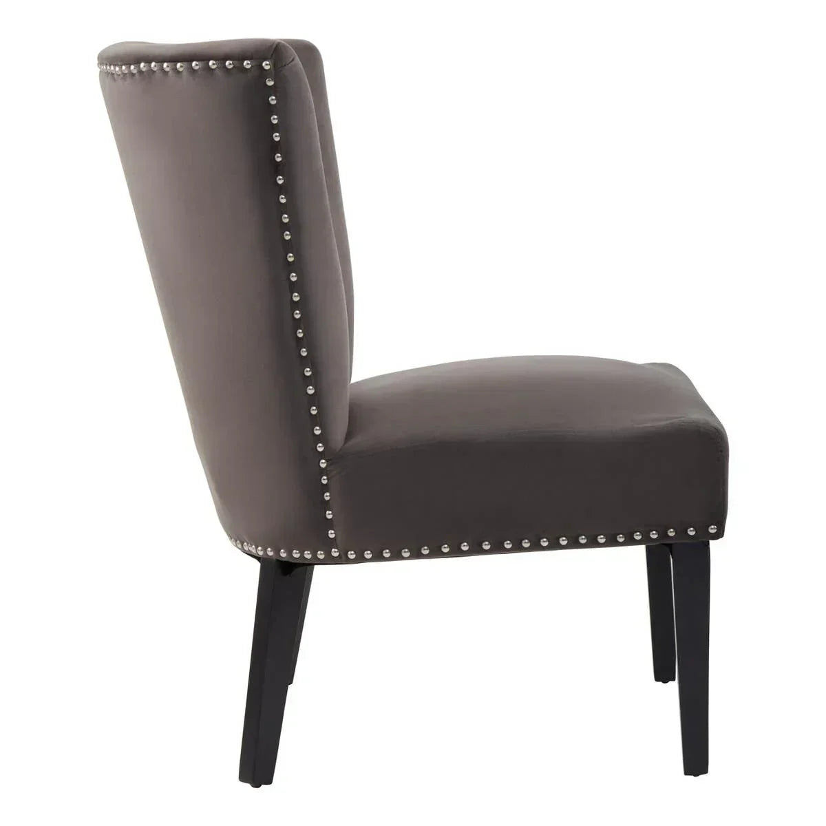 Side view of grey accent chair with studded trim and dark wooden legs