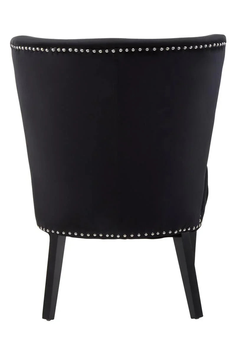 Back view of black accent chair with silver stud detailing and tapered black legs