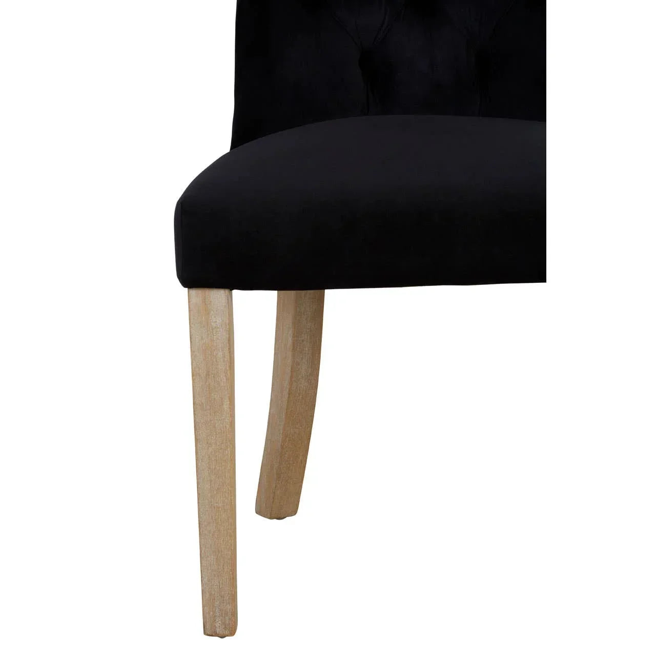 Black velvet dining chair seat with light wood legs and tufted back detail