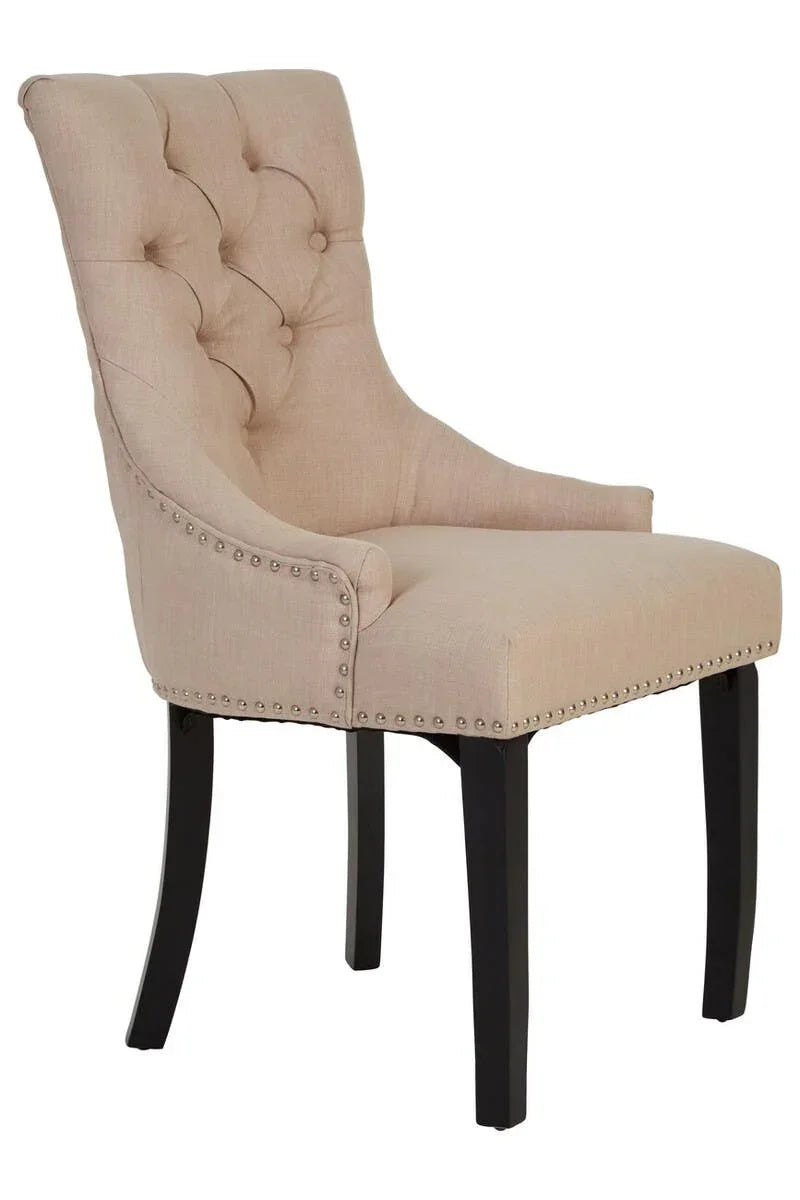 Beige upholstered dining chair with button tufted back and dark wooden legs