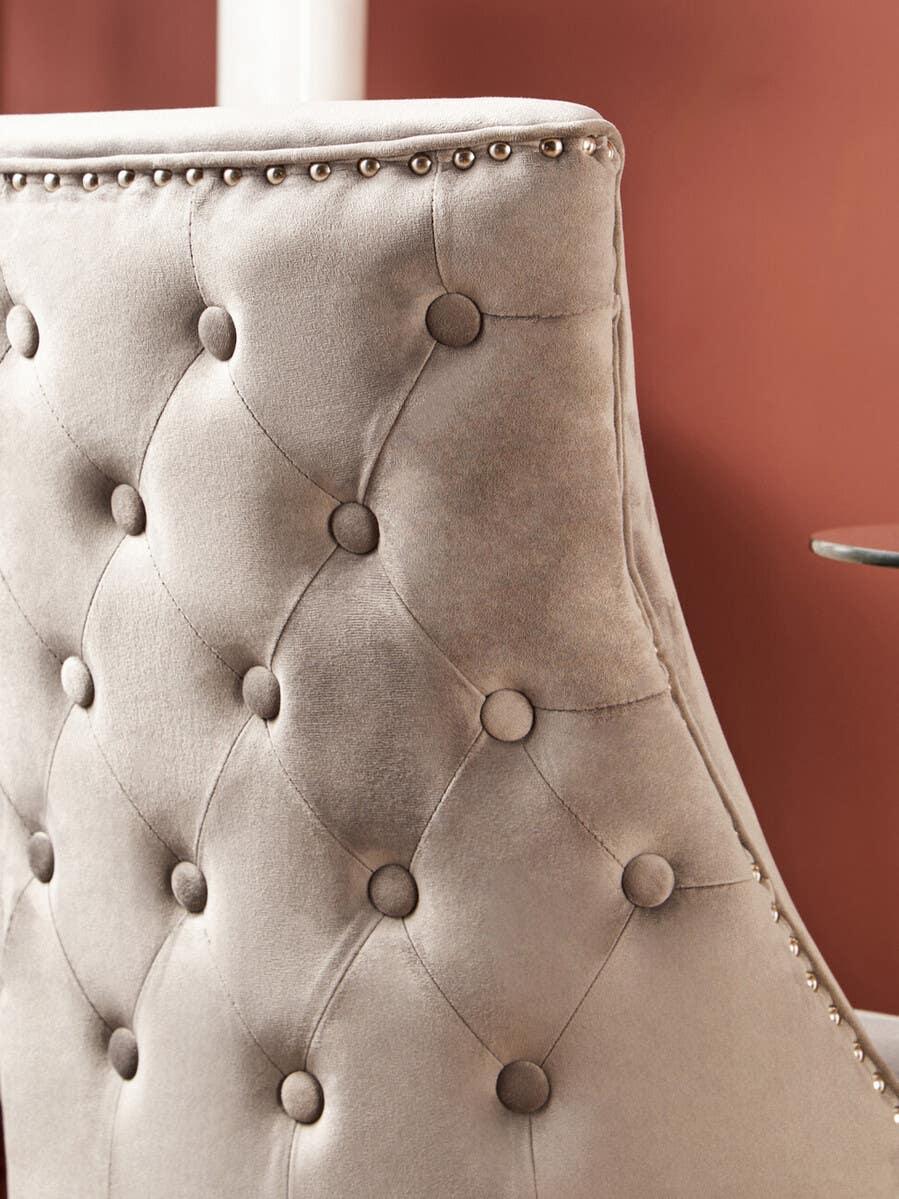 Velvet dining chair with tufted backrest and silver stud trim detail