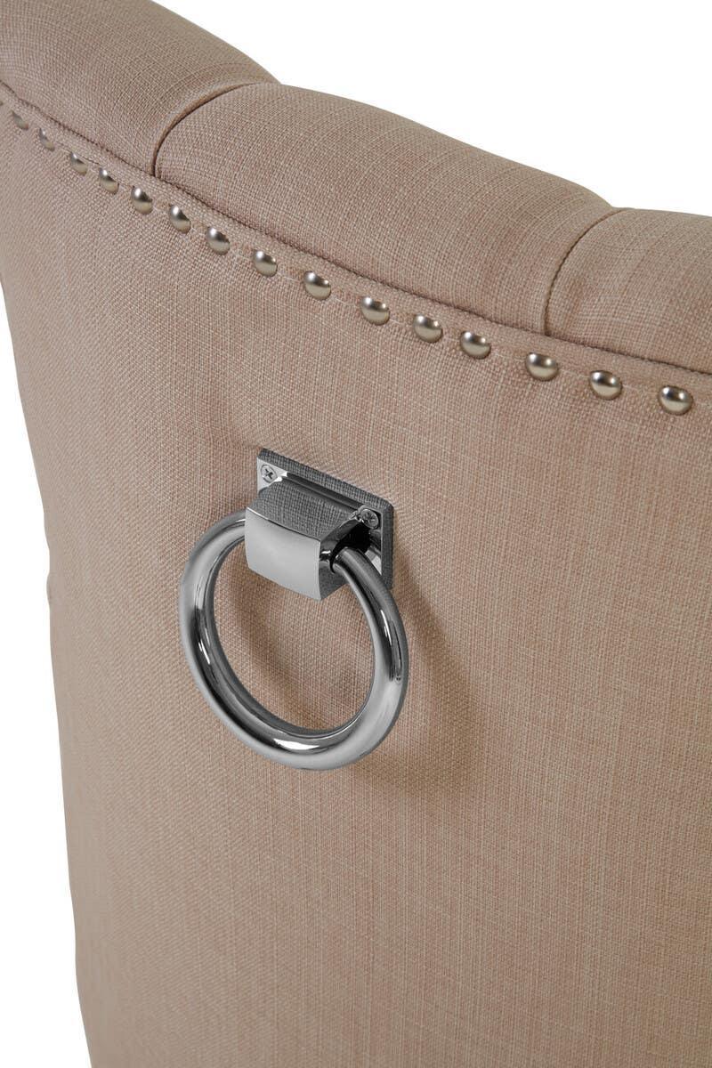 Beige upholstered dining chair back with silver ring handle and stud detail