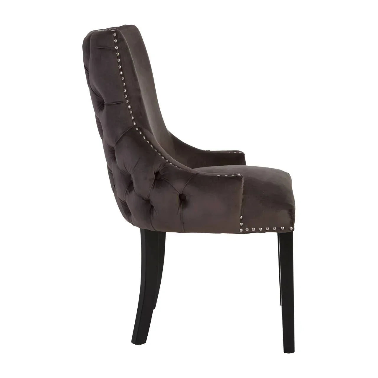Dark velvet dining chair with tufted back, studded trim and black wooden legs, side view