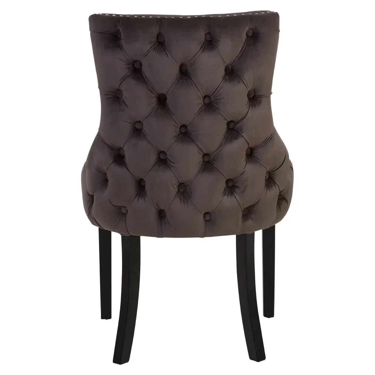 Brown velvet dining chair with button-tufted back and black wooden legs, rear view