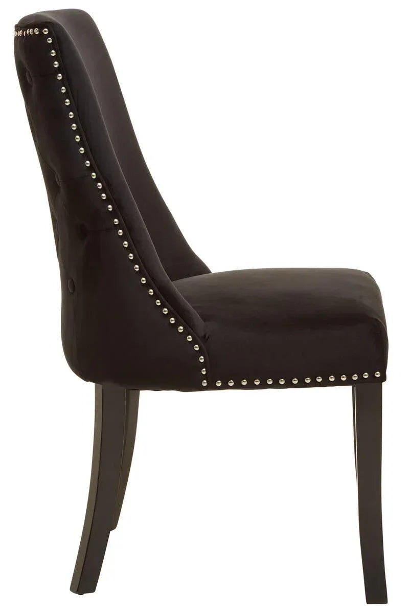 Black velvet dining chair with silver stud trim, side view