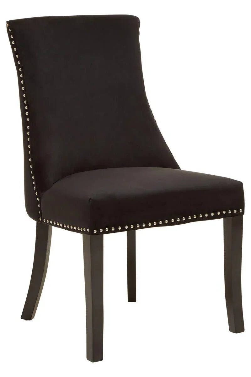 Black velvet dining chair with studded trim and dark wooden legs