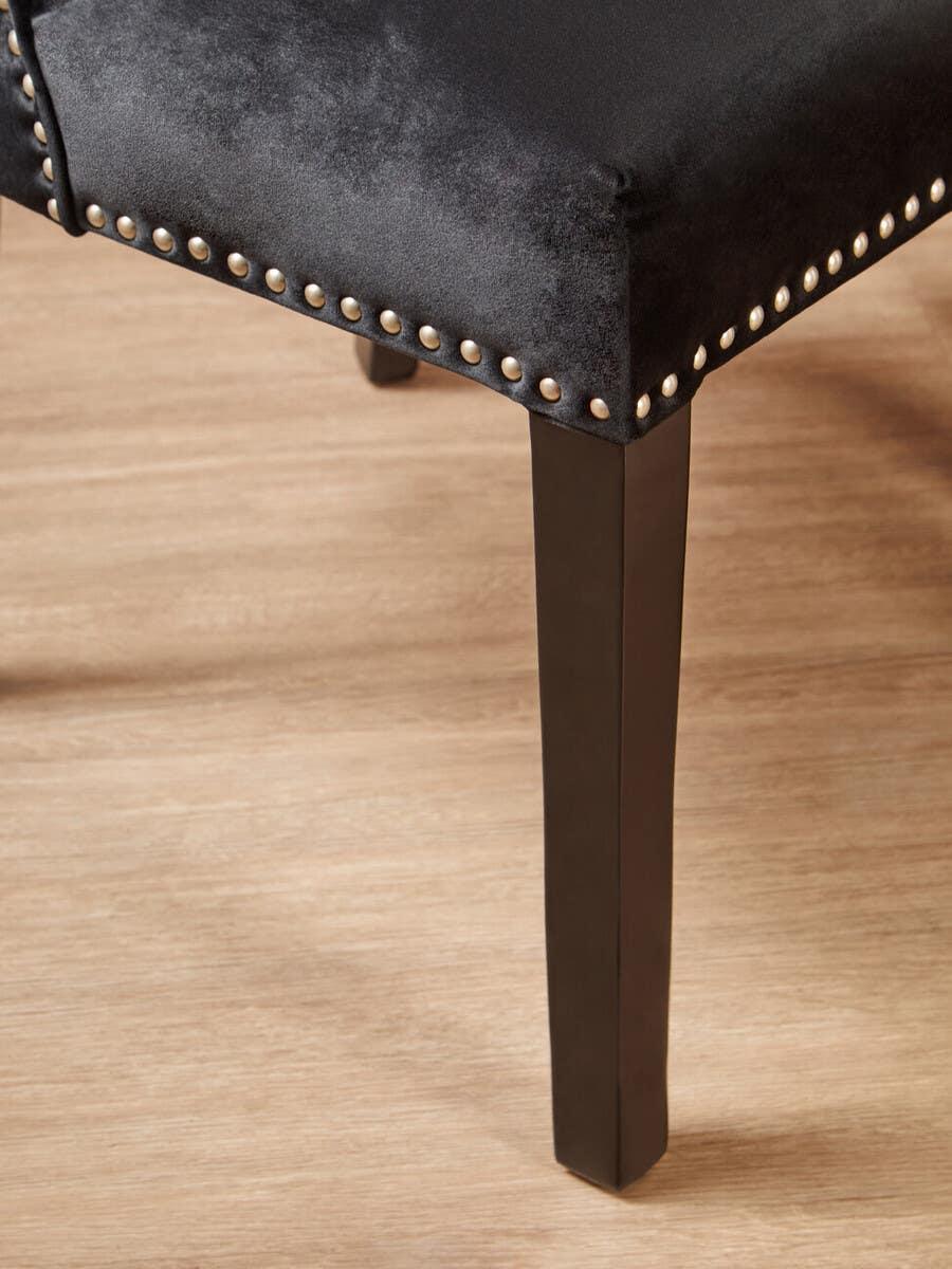 Black velvet dining chair seat with silver stud detailing and dark wooden leg