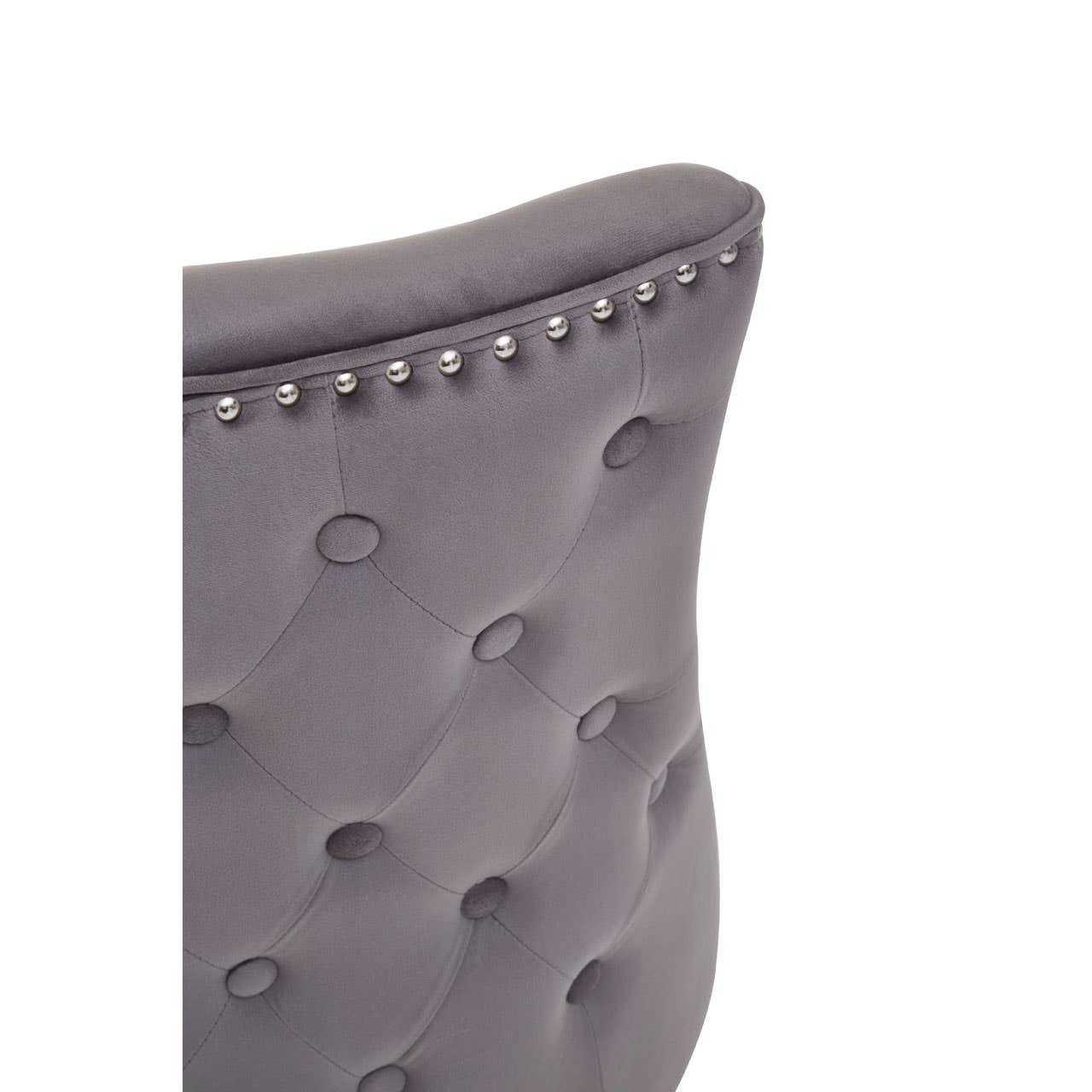 Grey velvet dining chair backrest with button tufting and silver stud detailing