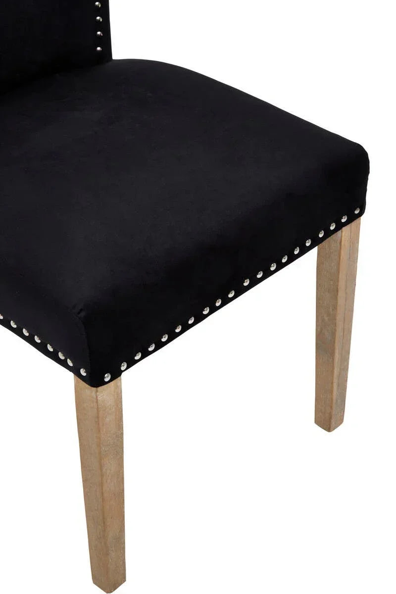 Black velvet dining chair seat with silver stud detail and wooden legs