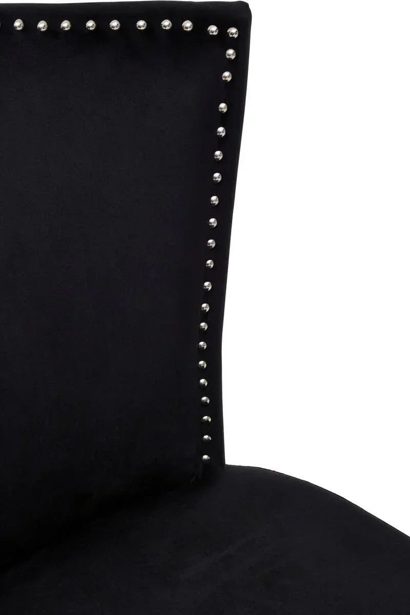 Close-up of black dining chair with silver stud detailing along the backrest edge