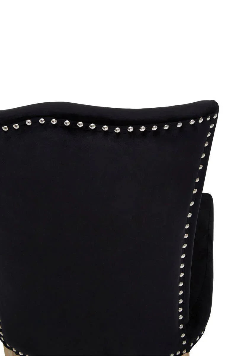 Black velvet chair back with silver stud detailing and curved top edge