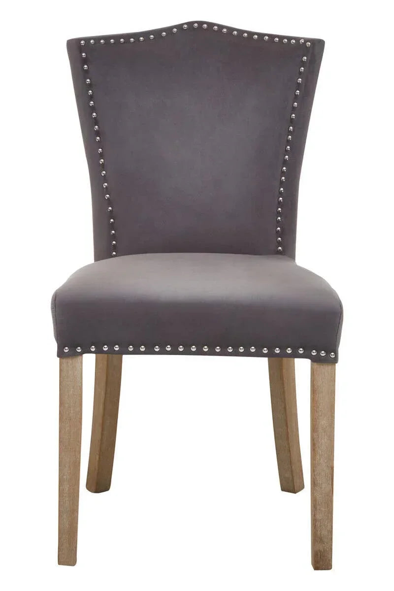 Grey upholstered dining chair with studded trim and light wooden legs, front view