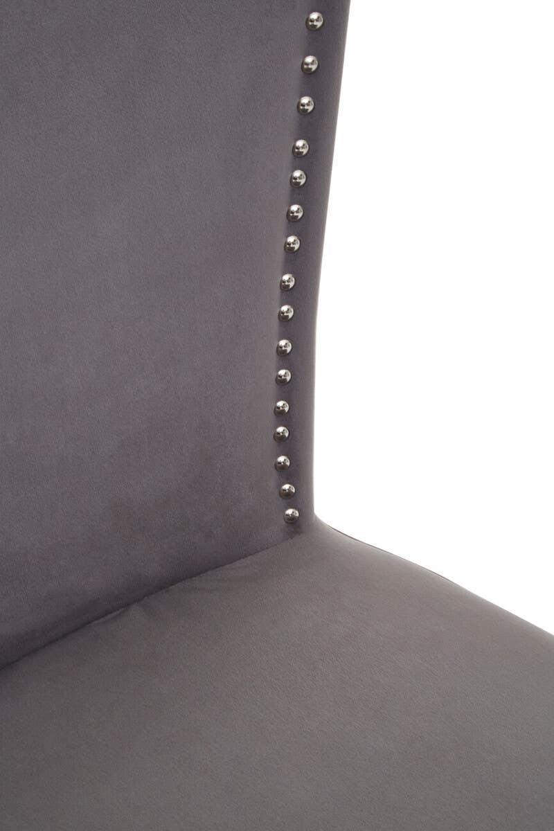 Grey velvet dining chair with silver stud detailing on backrest