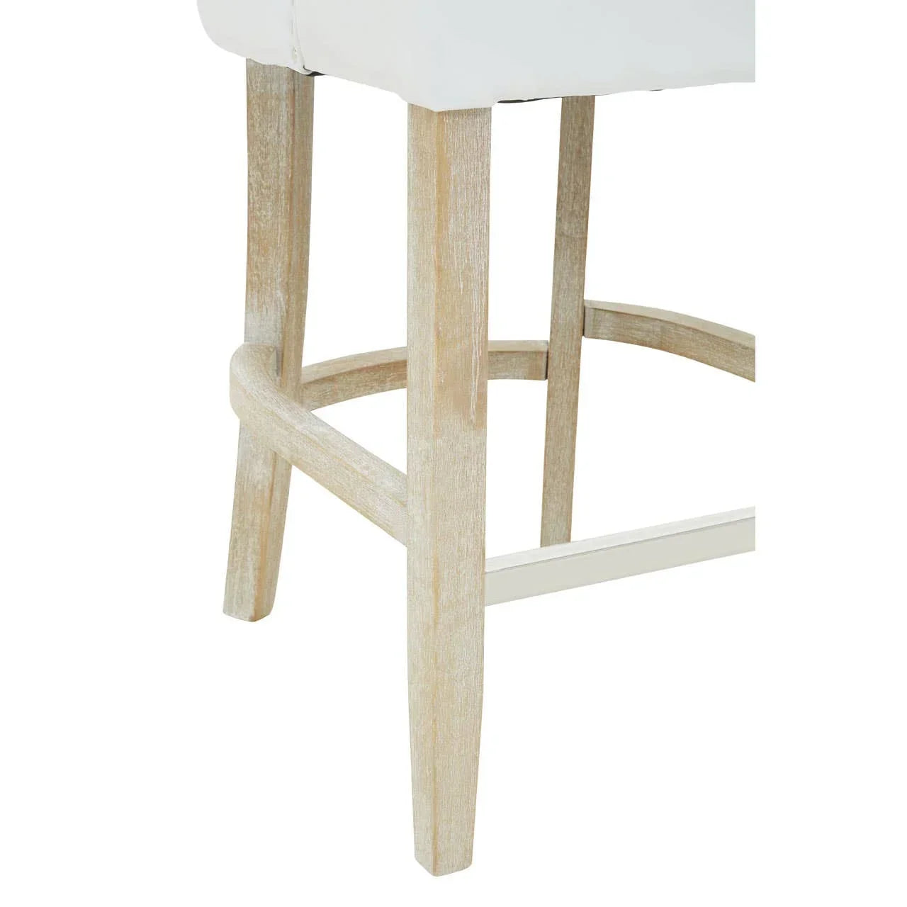 Closeup of bar stool with light wood legs and white padded seat