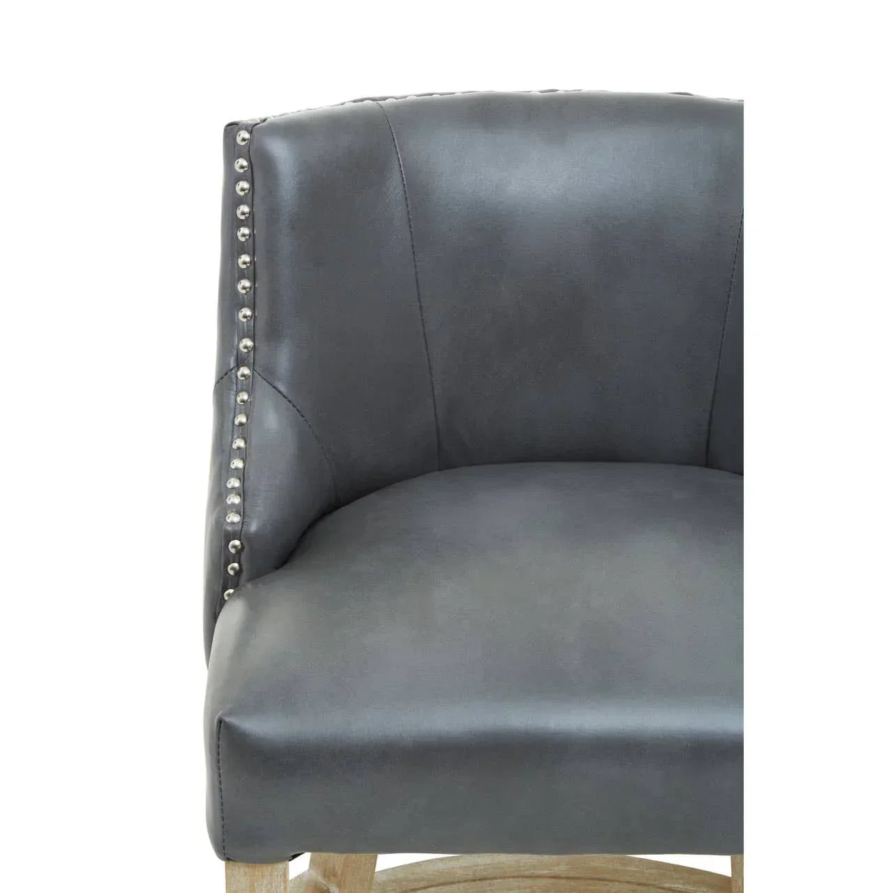 Grey leather accent chair with nailhead trim and wooden base, close-up of backrest