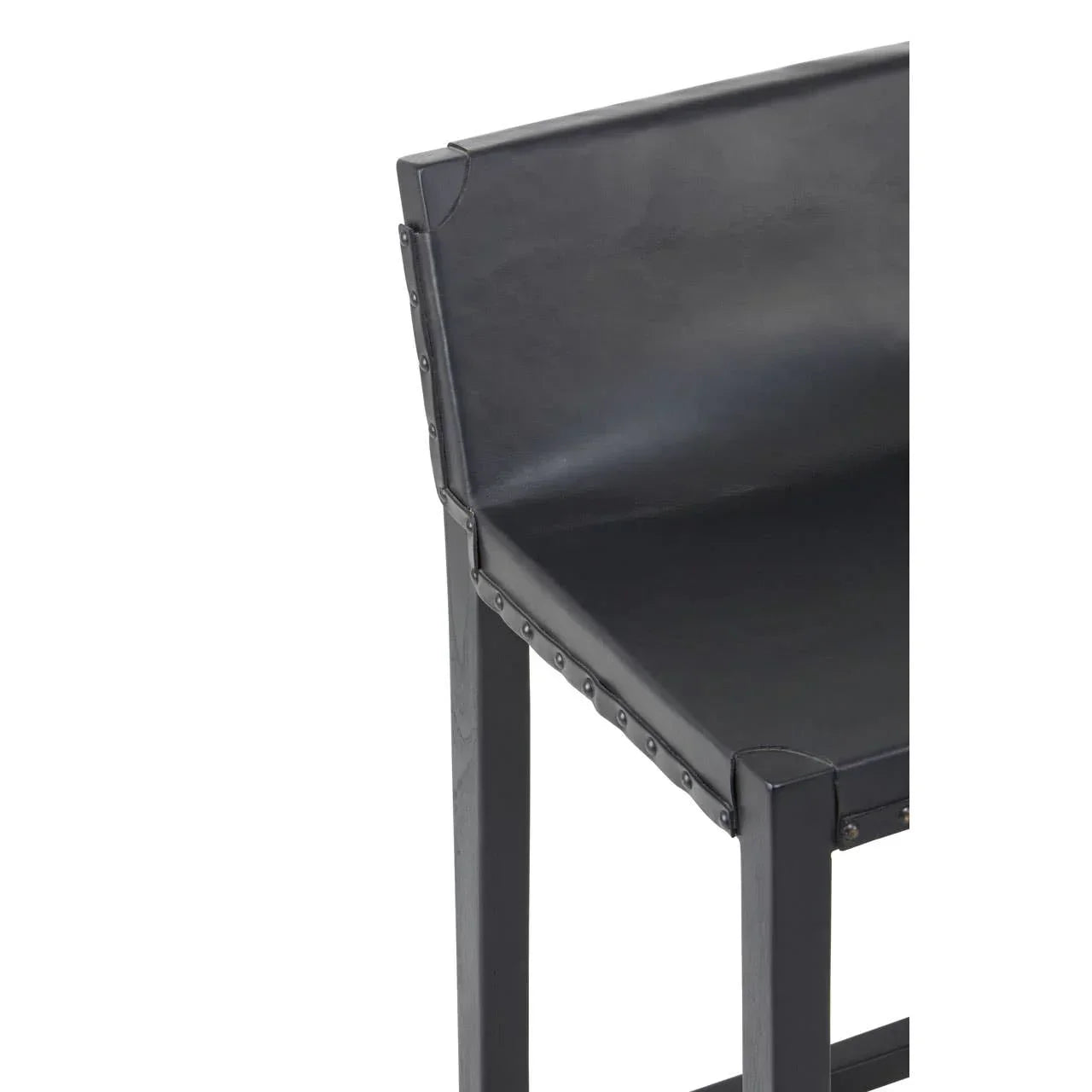 Black leather bar stool with metal rivet trim and square wooden legs, partial side view