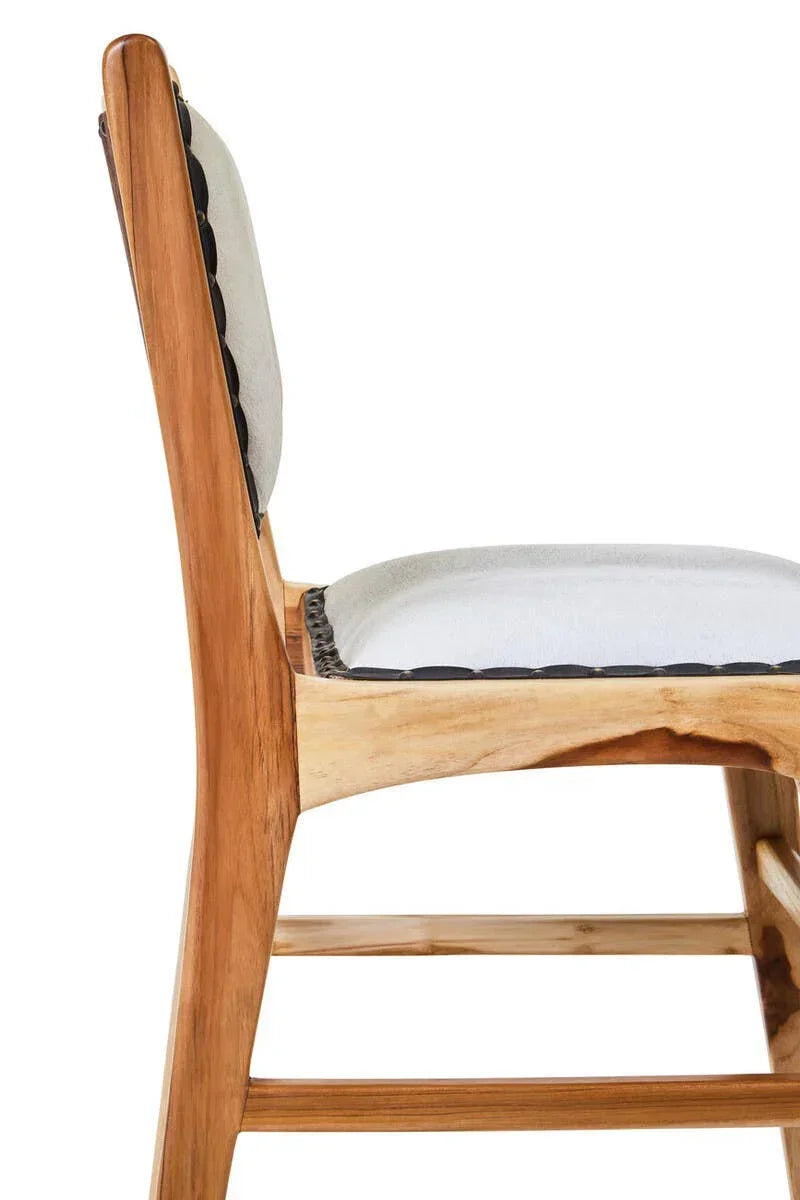 Side view of wooden dining chair with light grey upholstered seat and backrest