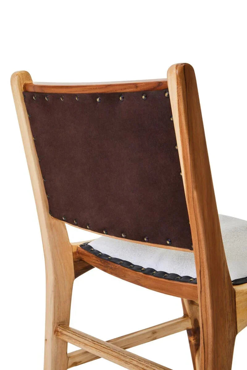 Wooden dining chair with brown suede backrest and stud detail, partial rear angle view