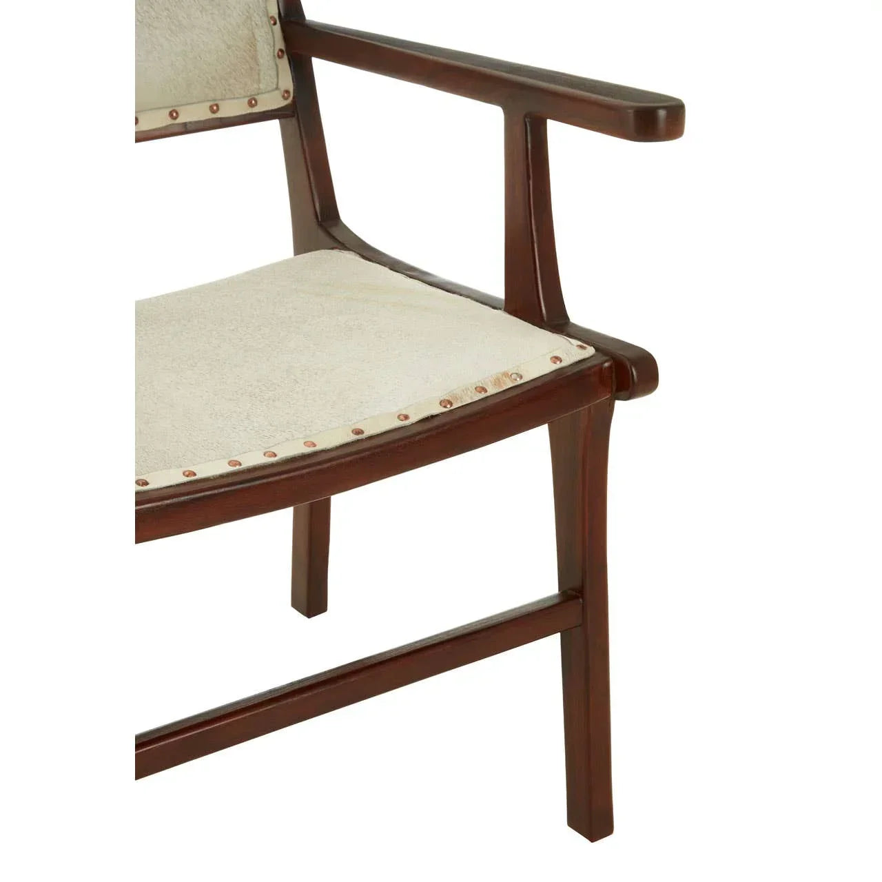 Closeup of wooden armchair with cream upholstered seat and decorative nail trim