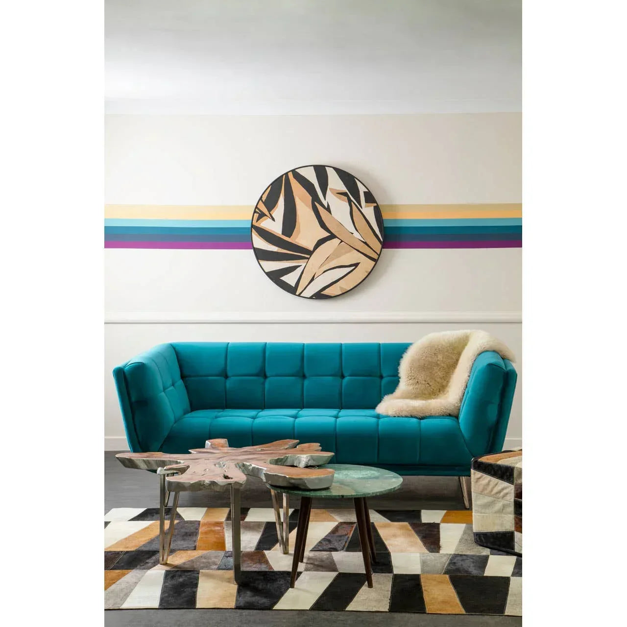 Teal fabric sofa with tufted upholstery, modern coffee tables, and geometric rug in living room